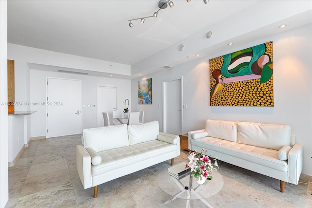 living room with light tile floors and track lighting