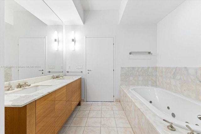 bathroom featuring a relaxing tiled bath, tile flooring, dual sinks, and vanity with extensive cabinet space