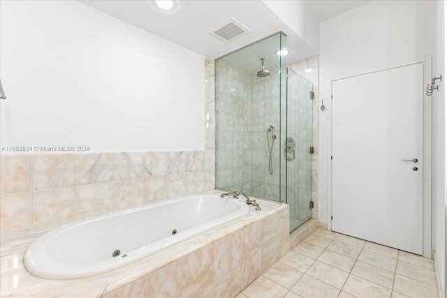 bathroom with separate shower and tub and tile flooring