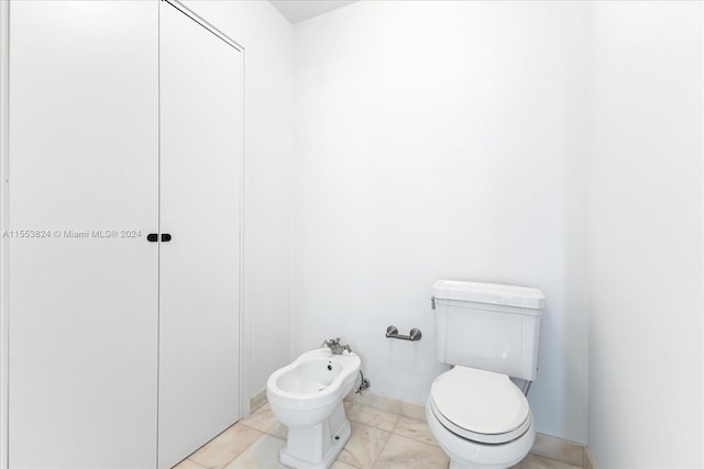 bathroom featuring a bidet, toilet, and tile flooring