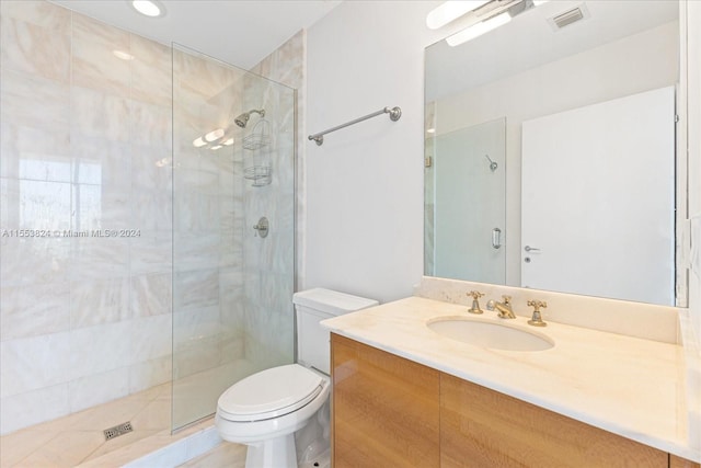 bathroom with toilet, a shower with shower door, and vanity