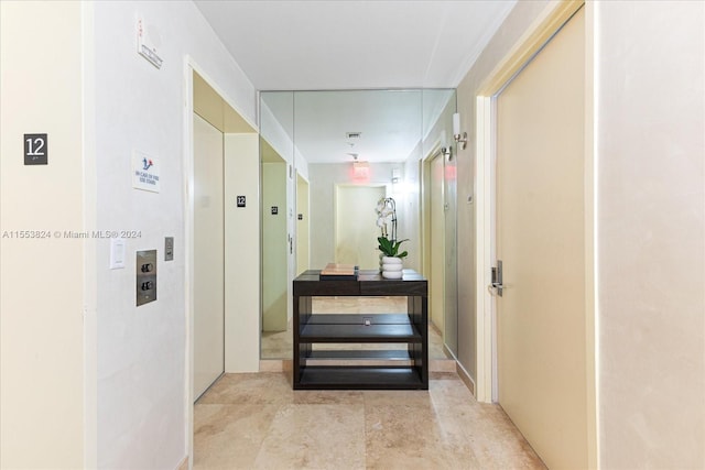 hallway featuring light tile flooring and elevator