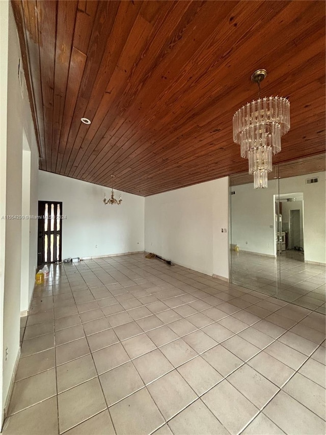 interior space with light tile patterned floors, visible vents, an inviting chandelier, and wooden ceiling