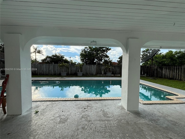 view of swimming pool featuring a patio area, a fenced backyard, and a fenced in pool