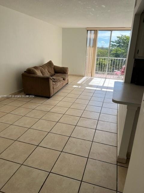 unfurnished living room featuring expansive windows and light tile floors