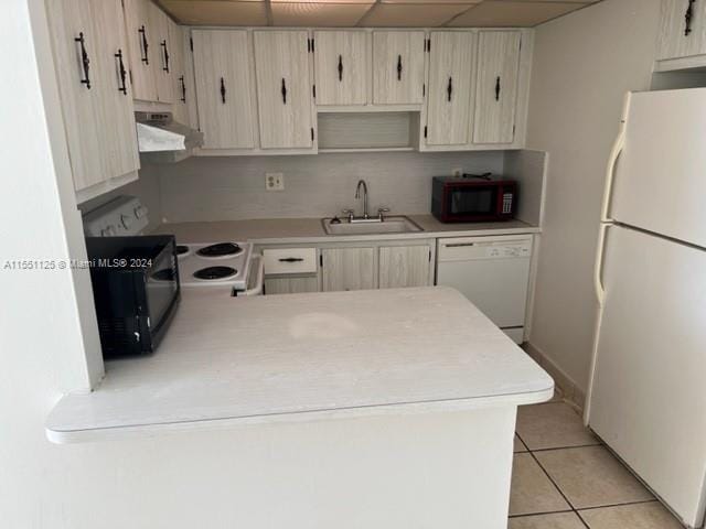 kitchen with white appliances, sink, and light tile floors