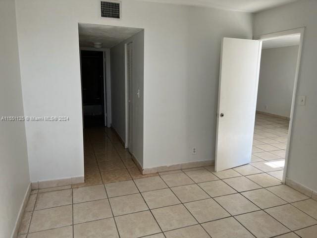 unfurnished room featuring light tile floors