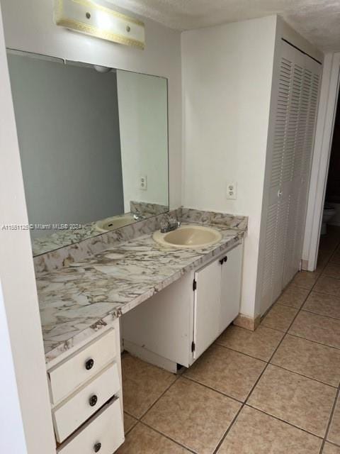 bathroom with tile flooring and vanity