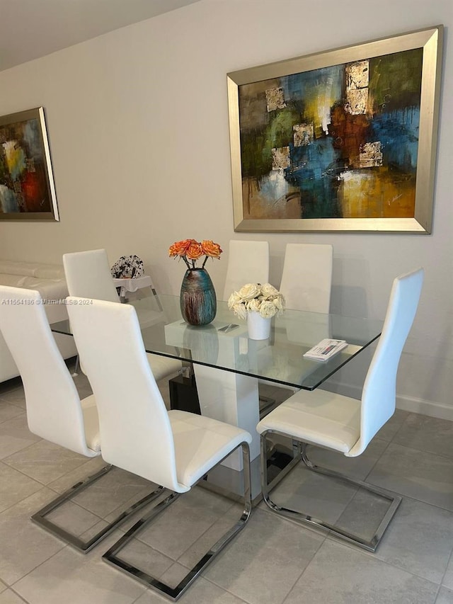 dining space with light tile flooring