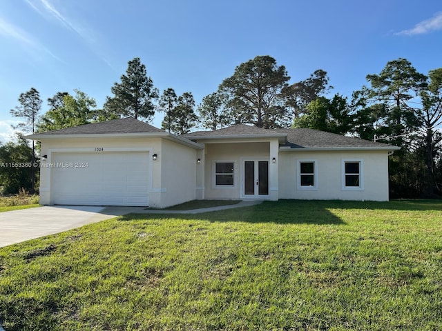 view of front of home featuring a front lawn and a garage