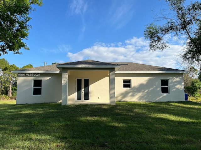 rear view of property with a lawn