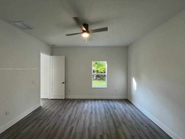 unfurnished room featuring ceiling fan and dark wood-type flooring