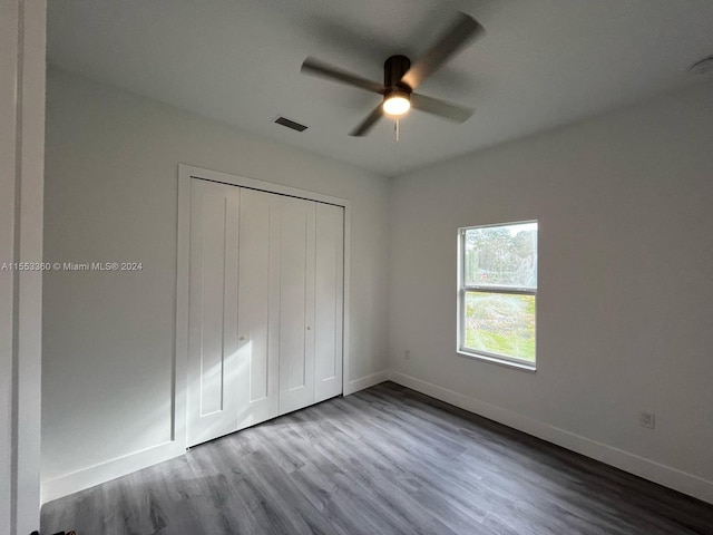 unfurnished bedroom featuring a closet, light hardwood / wood-style floors, and ceiling fan