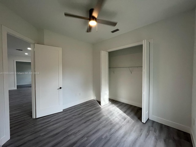 unfurnished bedroom with a closet, ceiling fan, and dark hardwood / wood-style floors