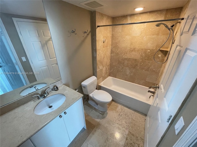 full bathroom with vanity, toilet, and tiled shower / bath