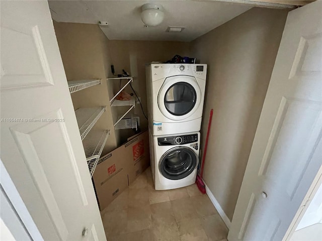 washroom featuring stacked washer and dryer