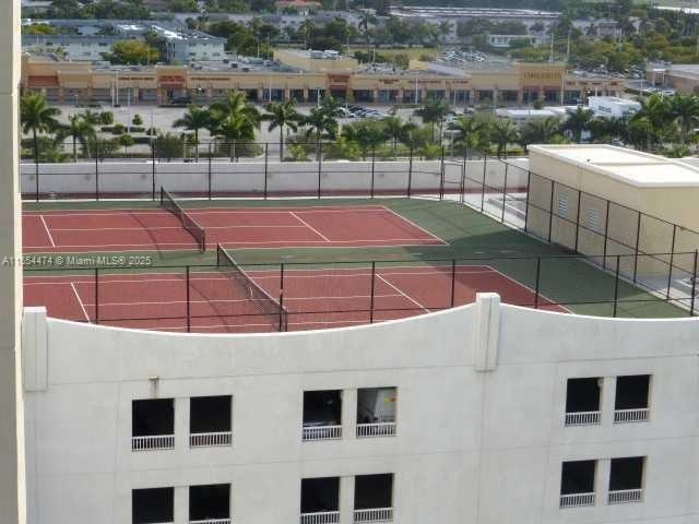 view of sport court with basketball hoop