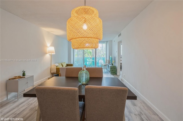 dining space with light wood-type flooring