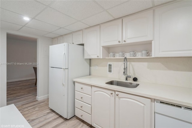 kitchen featuring a paneled ceiling, white cabinetry, light hardwood / wood-style floors, and sink