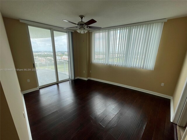 spare room featuring ceiling fan and dark hardwood / wood-style flooring