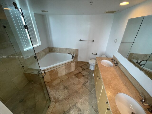 full bathroom with shower with separate bathtub, vanity, and toilet