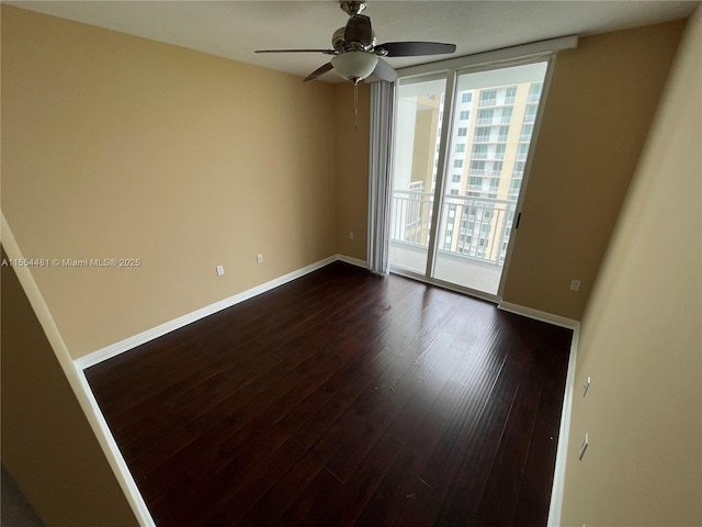 unfurnished room with ceiling fan and dark wood-type flooring