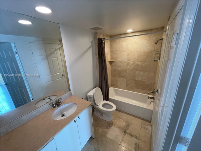 full bathroom with vanity, shower / bath combo, and toilet