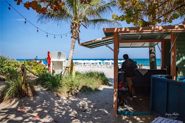 view of yard featuring a water view and a view of the beach