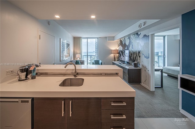 kitchen with dishwasher, dark brown cabinetry, and a kitchen island with sink