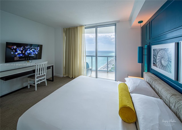 carpeted bedroom featuring expansive windows, access to exterior, and a water view