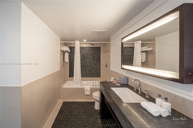 full bathroom featuring toilet, vanity, tile patterned floors, and shower / tub combo with curtain