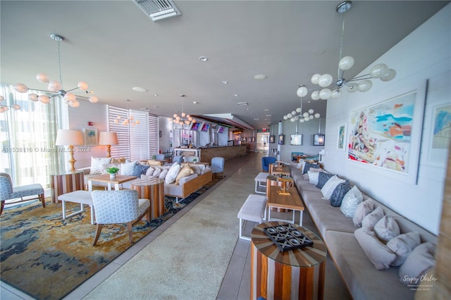 tiled living room featuring an inviting chandelier