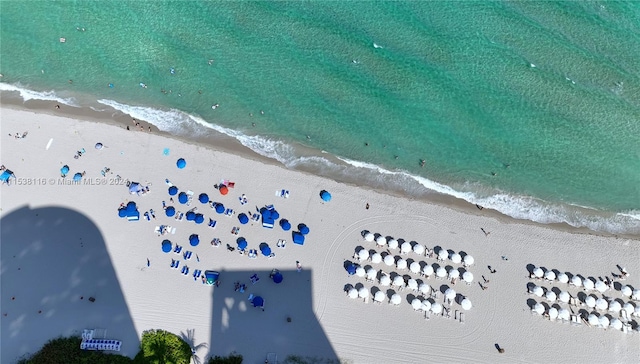 birds eye view of property with a water view and a view of the beach