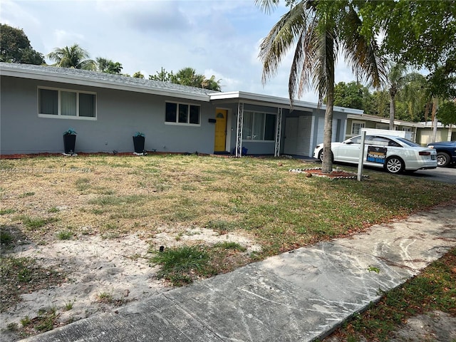 single story home featuring a front yard