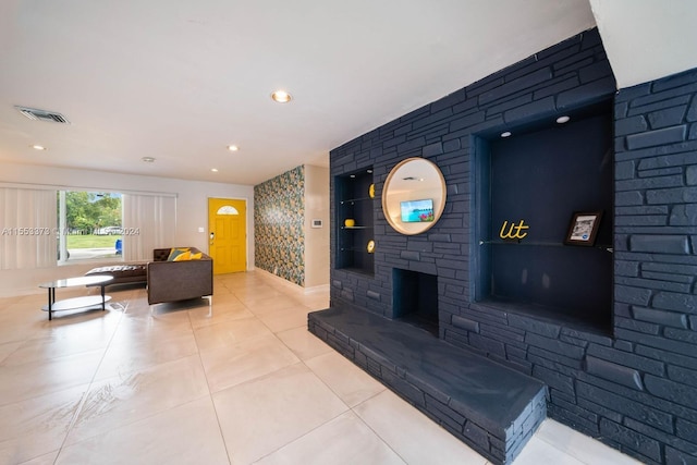 tiled living room featuring a fireplace