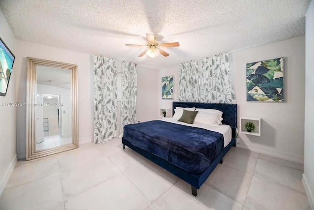 tiled bedroom with ceiling fan and a textured ceiling