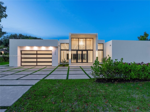 contemporary house with a yard and a garage