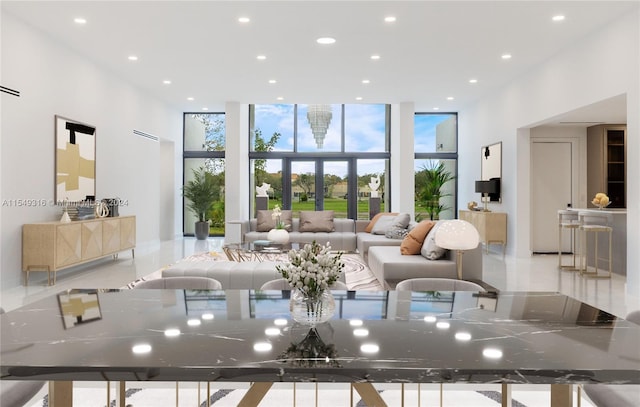 living room with a wall of windows and french doors