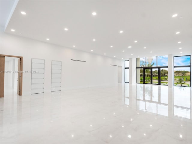 tiled empty room with floor to ceiling windows