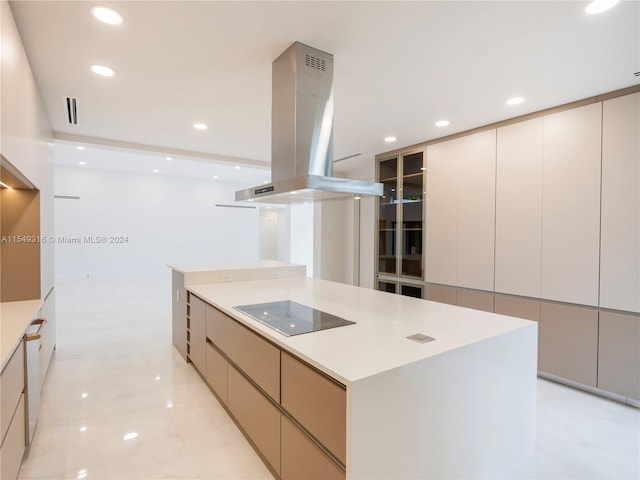 kitchen featuring island range hood, light tile floors, a center island, and black electric stovetop