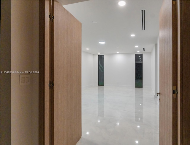 hall with light tile flooring