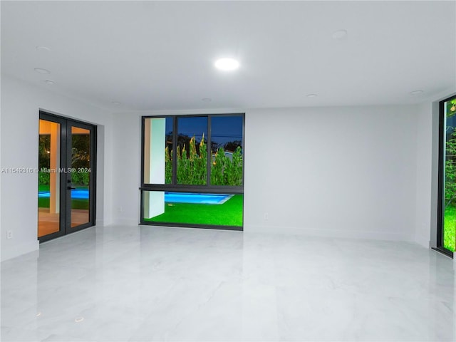 unfurnished room featuring french doors and light tile floors