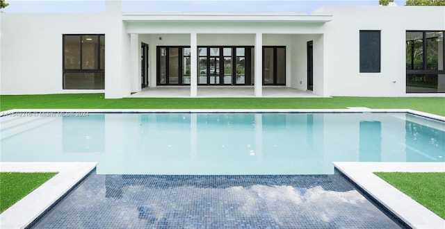 view of pool featuring a lawn and a patio area