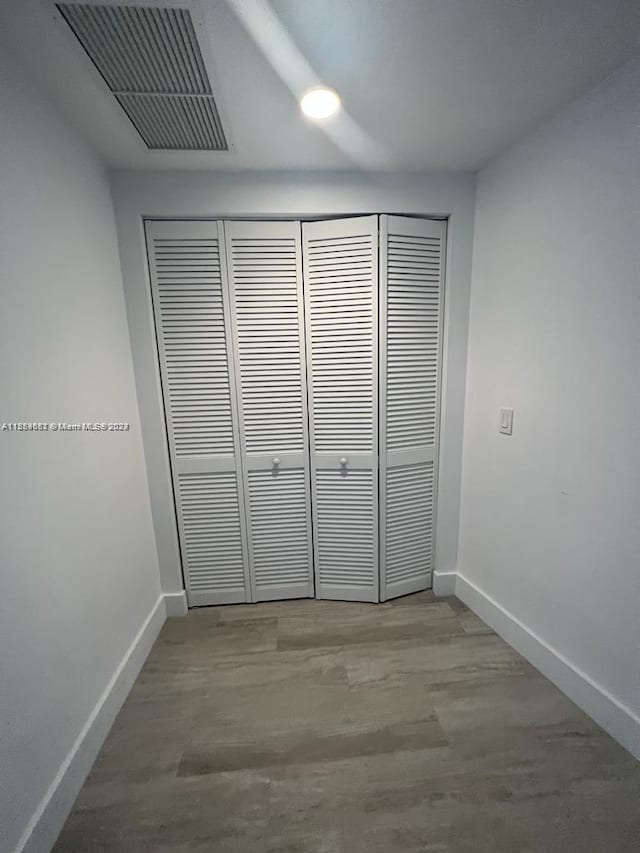 unfurnished bedroom with a closet and light wood-type flooring