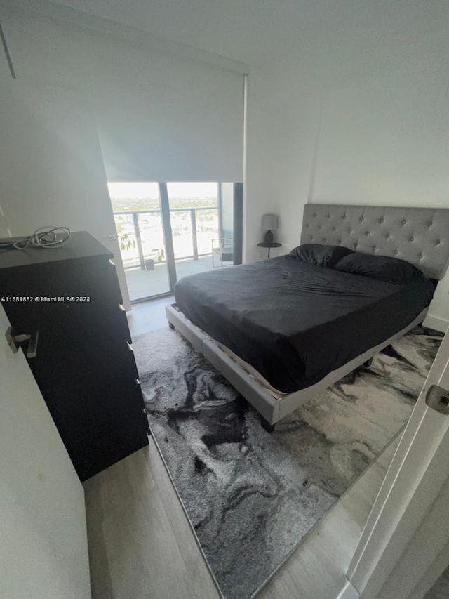 bedroom featuring access to outside, pool table, and light wood-type flooring