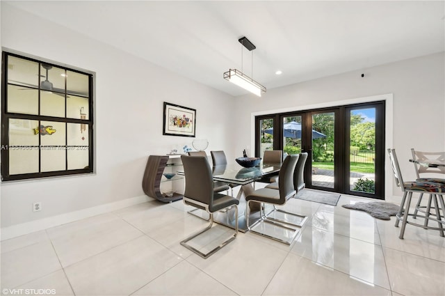 dining space with french doors and light tile flooring