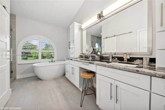 bathroom with double sink vanity, separate shower and tub, and tile floors