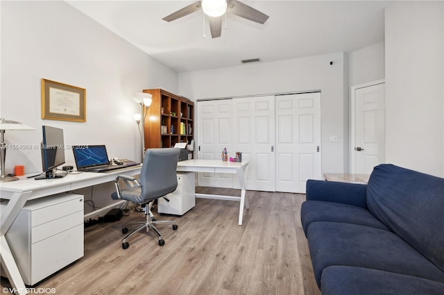 office featuring light hardwood / wood-style floors and ceiling fan