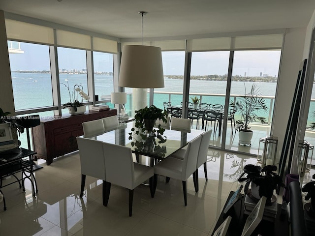 tiled dining space with a water view