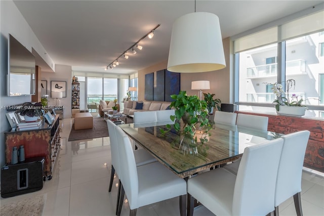 tiled dining space featuring track lighting